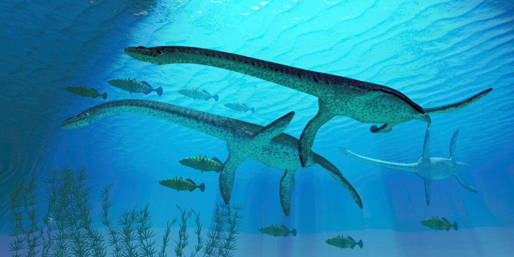 Plesiosaurus dinosaurs migrate along with a school of fish to warmer Jurassic seas.
